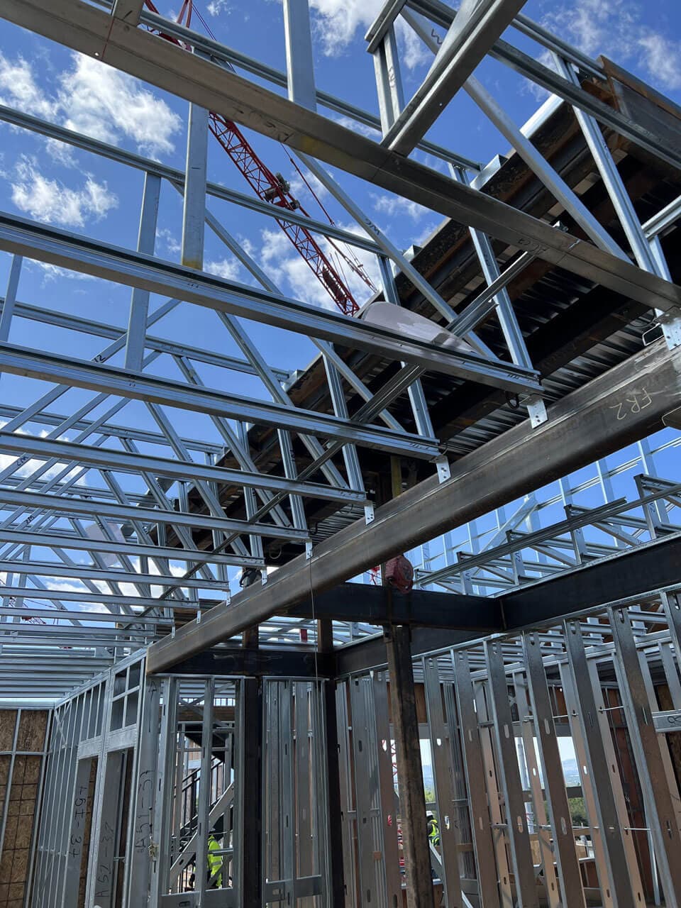 Prefabricated steel framing kit components staged for delivery